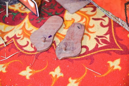 Photo for Traditional Hindu Wooden Sandals. Paduka. Maharashtra Culture. Indian Boy Traditional Shoes in Ceremony - Royalty Free Image