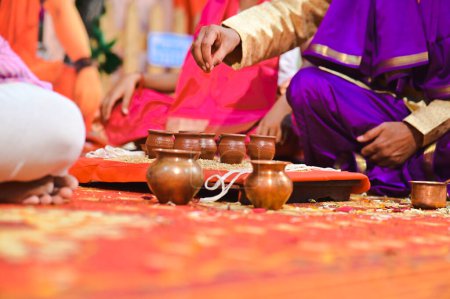Foto de Hombre con copas Kullad en adoración hindú. Copas de cerámica. Tazas de cerámica granos de trigo en adoración pooja. Ceremonia hindú y rituales. Cultura maharashtra - Imagen libre de derechos