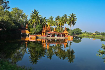 Photo for God Temple on the lake. Hindu Temple. Palm trees and lake. Blue Sky. Lovely Water reflection. Maharashta. india - Royalty Free Image