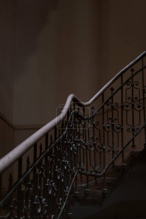 Openwork vintage staircase in an old house. Architecture of the 19th century. Forged railings. Vertical frame