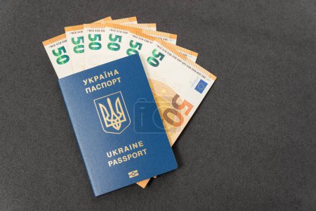 Money euros cash and Ukrainian Biometric passport. Concept monetary compensation or cash payments to Ukrainians. Travel.