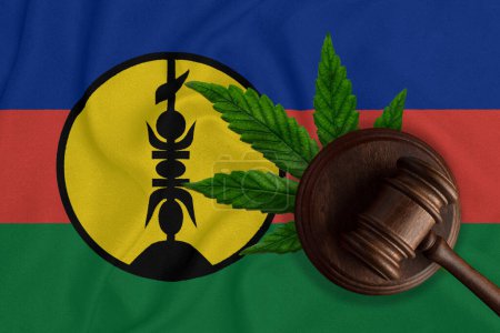 Flag of New Caledonia, green fresh cannabis leaf and Judicial wooden gavel. Illegal cultivation and distribution. Medical use