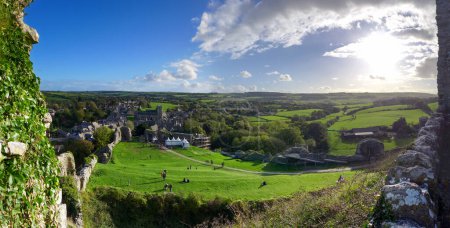 Photo for Corfe Castle, the village, taken from Corfe Castle, the castle, as the sun starts to set on an Autumn afternoon. - Royalty Free Image