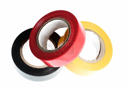 Foto de 129 / 500Pila de tres rollos de cinta adhesiva multicolor negra amarilla roja de cinta eléctrica como concepto de aislamiento de contacto eléctrico sobre fondo blanco - Imagen libre de derechos