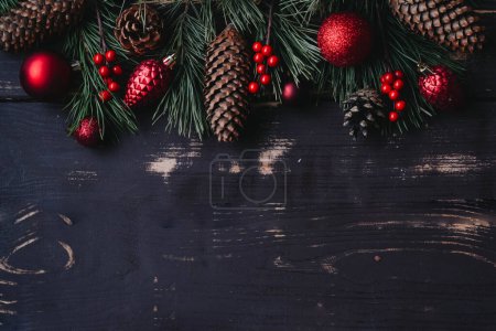 Photo for Christmass background red christmas tree toys and spruce brance on wooden background.. Xmas backdrop with space for text.Copyspace. - Royalty Free Image