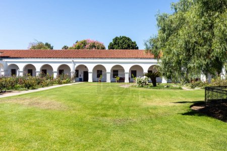 Photo for OCEANSIDE, CALIFORNIA, USA - SEPTEMBER 3, 2021: The Mission San Luis Rey courtyard, along with a pepper tree planted in 1830 and known as the first ever of its kind in California. - Royalty Free Image