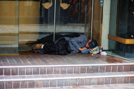 Photo for Perigueux, France September 02 2023 : A Stark Contrast: Homeless Individual Rests Outside Closed Shop. - Royalty Free Image