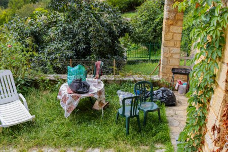 Photo for Castelaud la Chapelle, France, September 17, 2023: Tainted Beauty: A Garden Laden with Miscellaneous Items and Pollution - Royalty Free Image