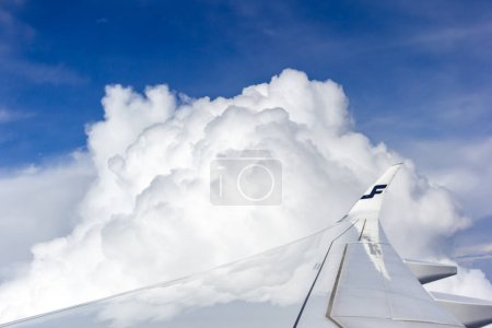 Photo for Airport Tokyo Narita, Japan, October 25 2023: Finnair Aircraft Right Wing Above the Clouds - Royalty Free Image