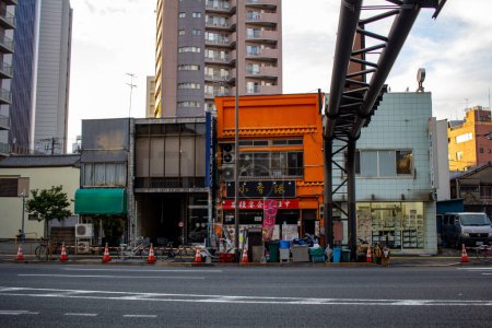 Photo for Tokyo, Japan, October 25, 2023: Contrast of Traditional Shops and Modern Construction in Tokyo - Royalty Free Image
