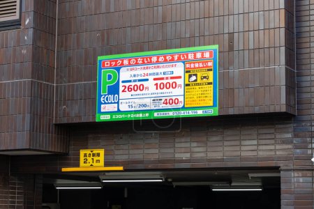 Photo for Tokyo, Japan, 26 October 2023: Public Parking Garage Sign Displaying Rates and Information - Royalty Free Image