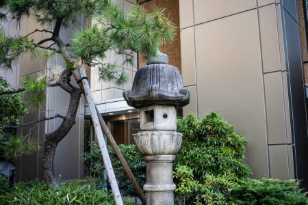 Photo for Tokyo, Japan, 26 October 2023: Traditional Japanese Lantern Amongst Modern Urban Landscaping - Royalty Free Image