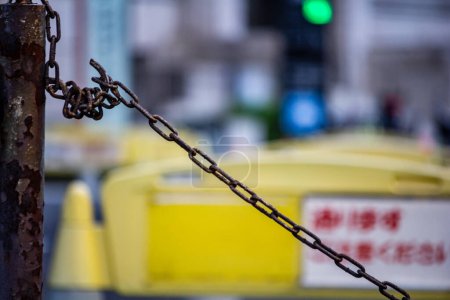 Photo for Tokyo, Japan, 26 October 2023: Rusty chain on a barrier at a construction site - Royalty Free Image