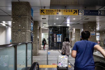 Photo for Tokyo, Japan, 26 October 2023: Man with luggage looking at subway station sign - Royalty Free Image