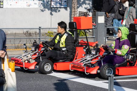 Photo for Tokyo, Japan, 28 October 2023: Tourists on Go-Karts at a Street Crossing - Royalty Free Image