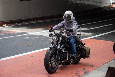 Photo for Tokyo, Japan, 29 October 2023: Motorcyclist Riding on City Street - Royalty Free Image