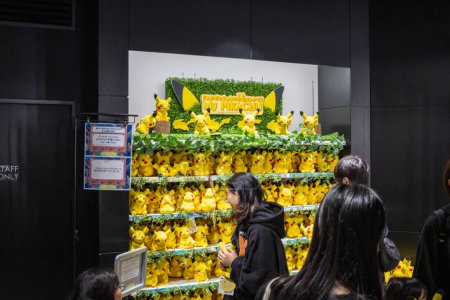 Photo for Tokyo, Japan, 29 October 2023: Customers admiring a Pikachu-themed display shelf in a store - Royalty Free Image