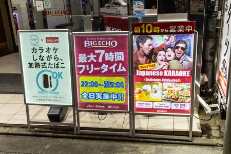 Photo for Tokyo, Japan, 29 October 2023: Advertisement boards for karaoke and food outside a Tokyo establishment - Royalty Free Image