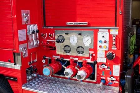Photo for Tokyo, Japan, 30 October 2023: Firefighting equipment and controls on the side panel of a fire truck - Royalty Free Image