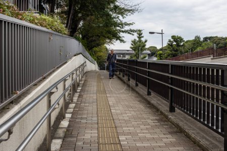 Photo for Tokyo, Japan, 31 October 2023: Elevated pedestrian walkway in urban Tokyo - Royalty Free Image