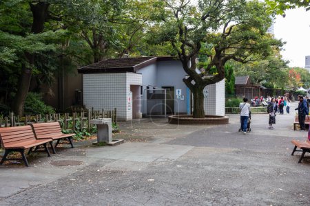 Photo for Tokyo, Japan, 31 October 2023: Park Rest Area with Visitors and Public Restrooms - Royalty Free Image