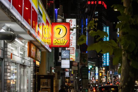 Photo for Tokyo, Japan, 31 October 2023: Vibrant street view with diverse shop signboards at night - Royalty Free Image
