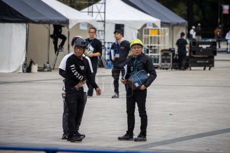 Photo for Tokyo, Japan, 31 October 2023: Security Team Monitoring an Outdoor Event - Royalty Free Image