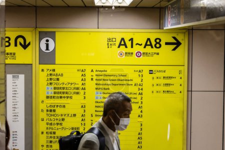 Photo for Tokyo, Japan, 31 October 2023: Person pointing at a subway station information board in Tokyo - Royalty Free Image