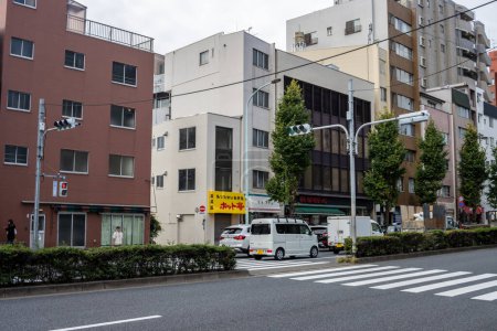 Photo for Tokyo, Japan, 31 October 2023: Urban street corner with mixed residential and commercial buildings - Royalty Free Image
