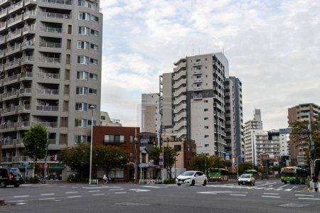 Photo for Tokyo, Japan, 31 October 2023: Busy intersection in Tokyo with apartment buildings and traffic - Royalty Free Image