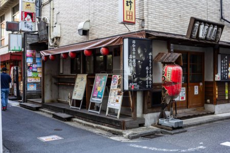 Photo for Tokyo, Japan, 1 November 2023: Quaint restaurant entrance with red lanterns and menu display - Royalty Free Image