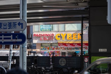 Photo for Tokyo, Japan, 1 November 2023: Colorful Pachinko and slot game center with bicycles parked outside - Royalty Free Image