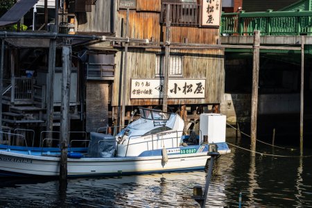 Foto de Tokio, Japón, 1 de noviembre de 2023: Antiguos edificios de madera a lo largo del río con un barco amarrado - Imagen libre de derechos