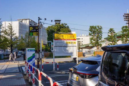 Photo for Tokyo, Japan, 1 November 2023: Parking lot entrance with electronic sign and fee information - Royalty Free Image