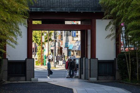 Photo for Tokyo, Japan, 1 November 2023: View through a Torii Gate to a Busy Tokyo Street - Royalty Free Image
