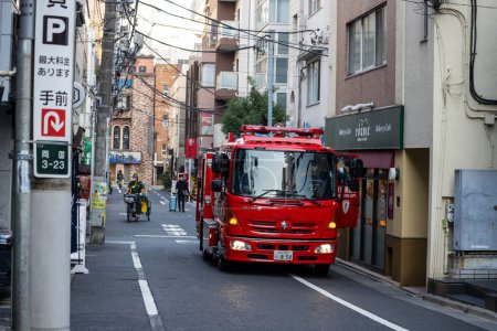 Photo for Tokyo, Japan, 1 November 2023: Fire Engine Navigating Through Tokyo Street - Royalty Free Image