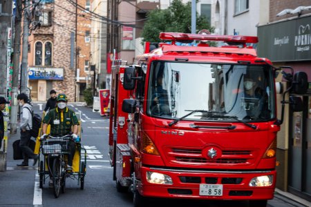 Photo for Tokyo, Japan, 1 November 2023: Fire Engine Navigating Through a Narrow Street in Tokyo - Royalty Free Image