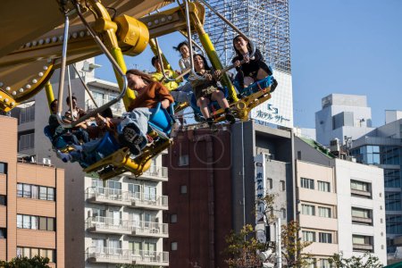 Photo for Tokyo, Japan, 2 November 2023: Amusement Park Ride in Urban Setting - Royalty Free Image