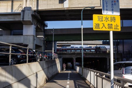 Photo for Tokyo, Japan, 3 November 2023: Pedestrian walkway under city bridge - Royalty Free Image
