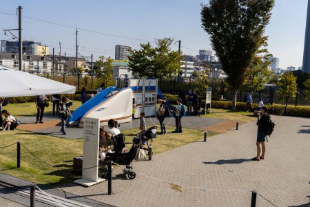 Téléchargez les photos : Tokyo, Japon, 3 novembre 2023 : Visiteurs à l'exposition extérieure d'un train à balles japonais avec Shinkansen en arrière-plan - en image libre de droit