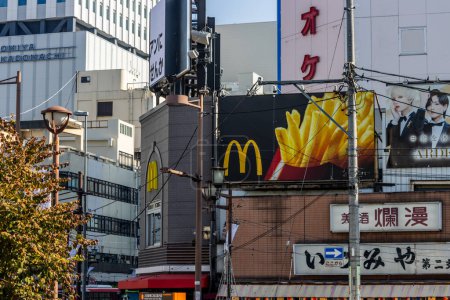 Photo for Tokyo, Japan, 3 November 2023: Advertisement billboards and signs on a building in urban Tokyo - Royalty Free Image