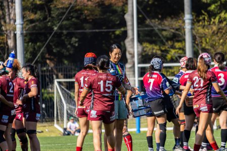 Photo for Tokyo, Japan, 4 November 2023: Women's Rugby Team During a Break in a Match with Player Number 15 in Focus - Royalty Free Image