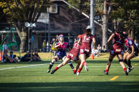 Photo for Tokyo, Japan, 4 November 2023: Dynamic Play at a Women's Rugby Game with Players Running and Passing the Ball - Royalty Free Image