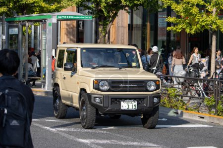Photo for Tokyo, Japan, 4 November 2023: Beige SUV in Urban Traffic on a Sunny Day - Royalty Free Image