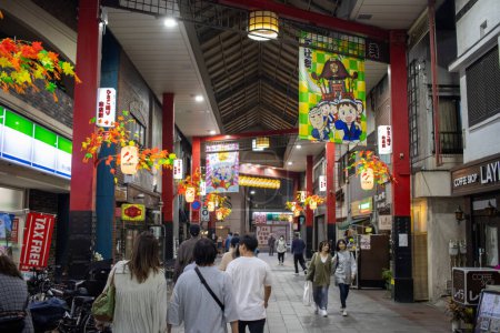 Photo for Tokyo, Japan, 4 November 2023: Bustling Shopping Arcade in Tokyo with Anime Banners and Autumn Decorations - Royalty Free Image
