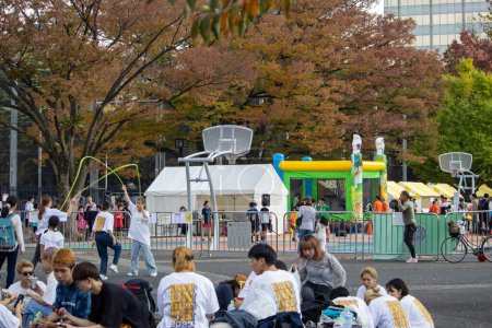 Photo for Tokyo, Japan, 4 November 2023: Casual Urban Event Featuring Street Basketball and a Bounce House in a Tokyo Park - Royalty Free Image