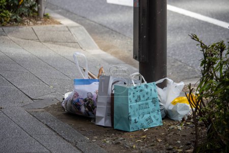Photo for Tokyo, Japan, November 4 2023: Discarded Shopping Bags on City Street - Royalty Free Image