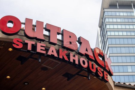 Tokio, Japonia, 4 listopada 2023: Outback Steakhouse Signage with Modern Building background