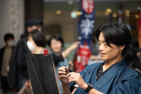Photo for Tokyo, Japan, November 5 2023: Traditional Japanese Calligraphy Artist at Work - Royalty Free Image