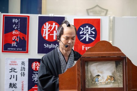 Photo for Tokyo, Japan, November 5 2023: Traditional Japanese Storyteller Performing Kamishibai - Royalty Free Image